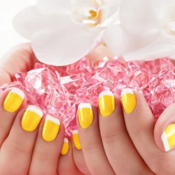 Yellow French-tip nail enhancements with crystals