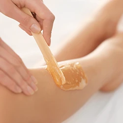Leg waxing with warm amber wax